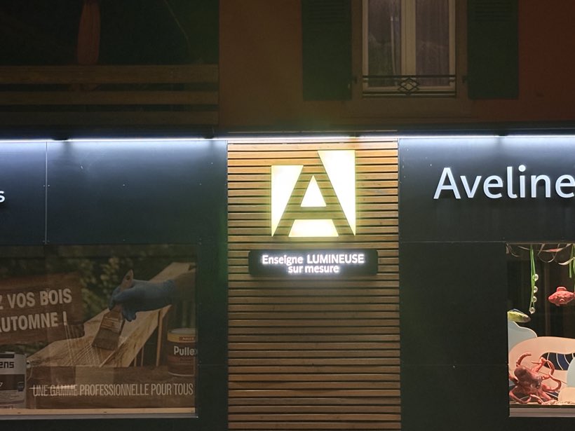 Le A entre deux vitrines, Enseigne lumineuse, façade du magasin